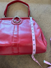 Vintage red leather shoulder bag purse with a top handle and a metal ring detail