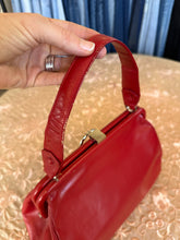 Vintage red leather shoulder bag purse with a top handle and a metal ring detail