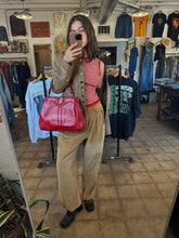 Vintage red leather shoulder bag purse with a top handle and a metal ring detail